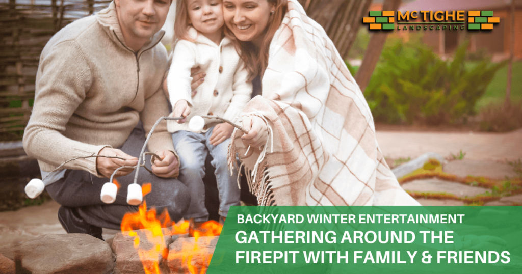 Man, woman and child family gathering around the firepit roasting marshmallows